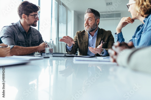 Businessman explaining new business ideas to colleagues
