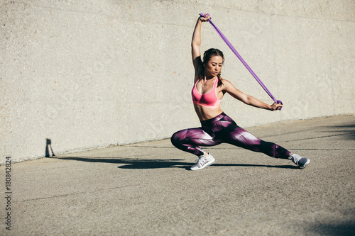 Strong woman stretching using a resistance band