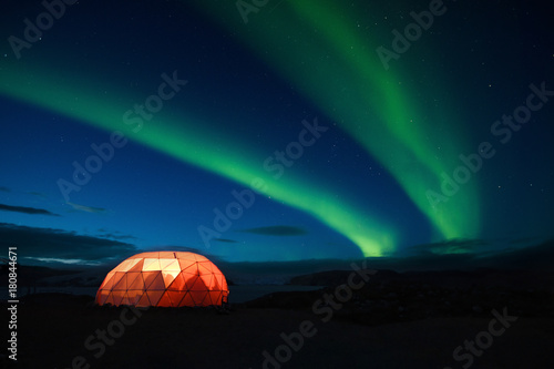 Aurora boreale con tenda illuminata, Groenlandia photo