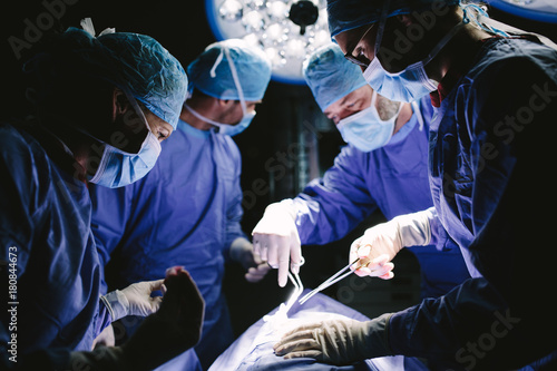 Fotografie Medical team performing surgical procedure in operating theater