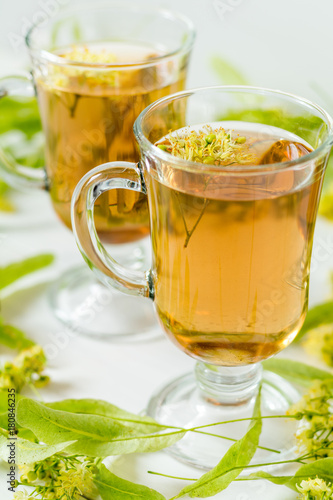Linden herbal tea in transparent grog glass