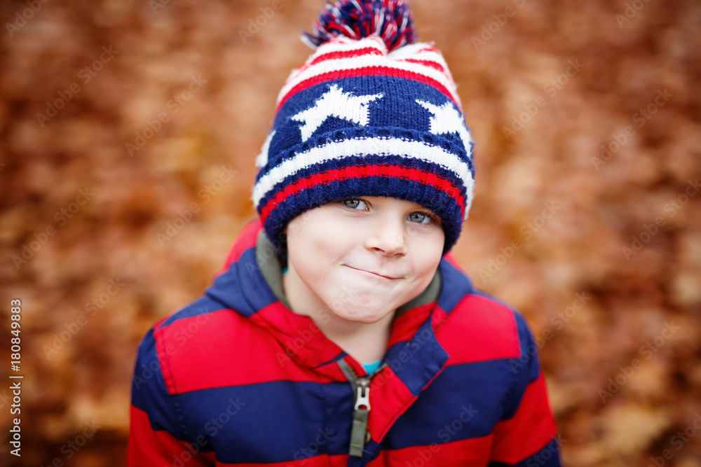 Cute little kid boy on autumn leaves background in park. Cute little kid boy on autumn leaves background in park.