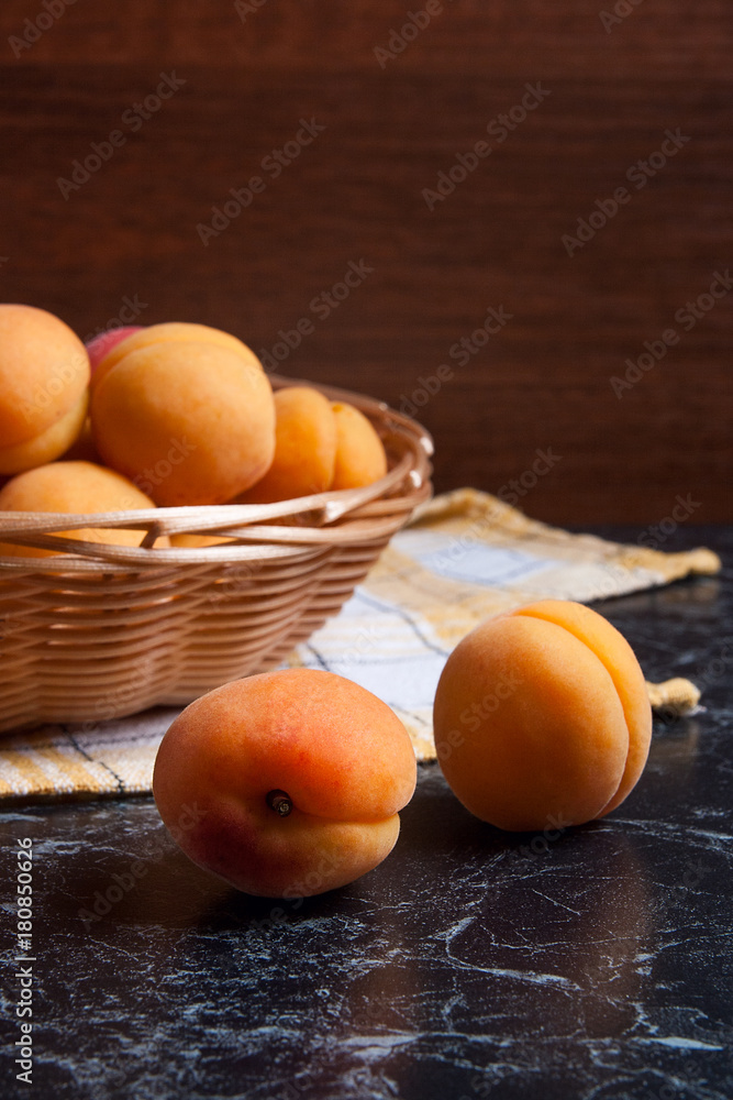 Fresh organic apricots in basket. Group of harvested apricots in basket.. Fresh organic apricots in basket. Group of harvested apricots in basket..