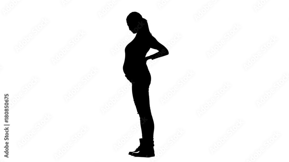 Pregnant woman is standing and stroking her stomach. Silhouette. White background. Slow motion Pregnant woman is standing and stroking her stomach. Silhouette. White background. Slow motion