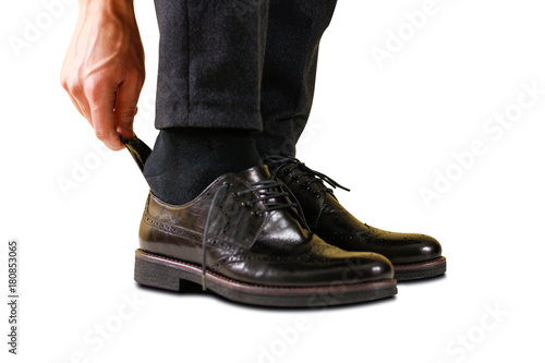 Wearing black shoes with a spoon. Isolated on white background