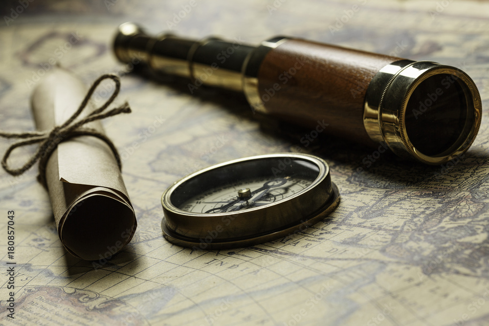 Retro compass with old map and spyglass