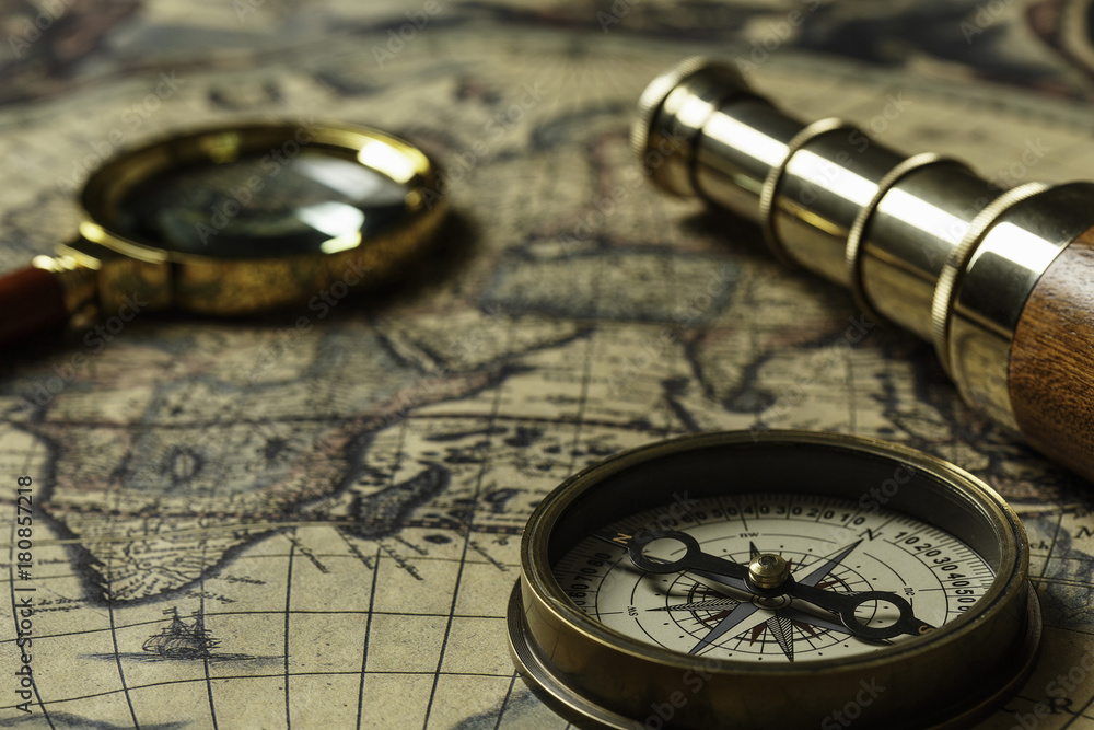 Retro compass with old map and spyglass Retro compass with old map and spyglass