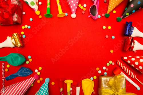 children party background. birthday background. Colorful party frame with  cap and whistle  on red background