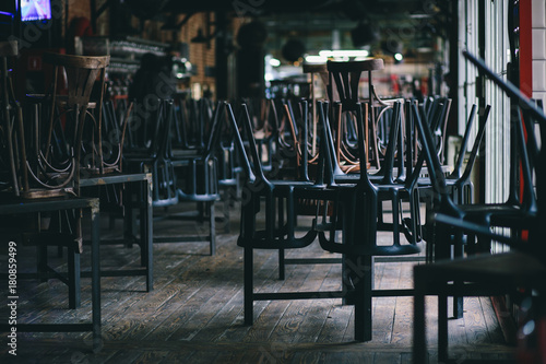 Chairs and tables stacked in a closed pub photo