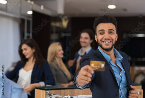 Latin Man In Suit Hold Credit Card Happy Smiling While Shopping In Elegant Menswear Store  Businessman Buy Clothes