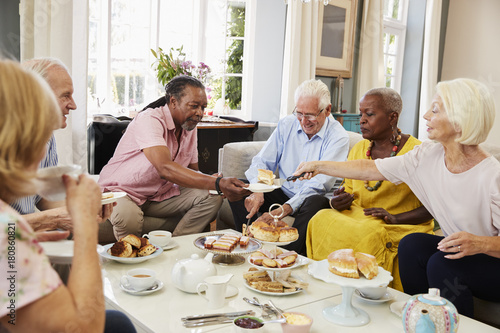 Photos Group Of Senior Friends Enjoying Afternoon Tea At Home Together
