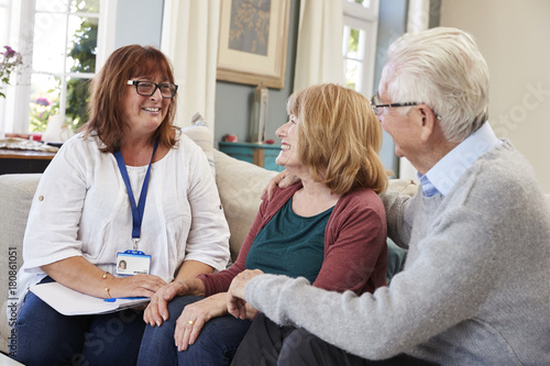Female Support Worker Visits Senior Couple At Home photo