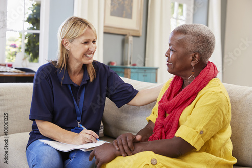 Female Support Worker Visits Senior Woman At Home photo