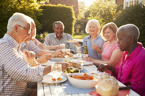 Photography Group Of Senior Friends Enjoying Outdoor Dinner Party At Home