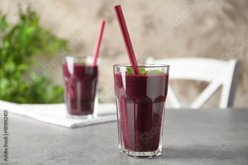 Glass with acai juice on table