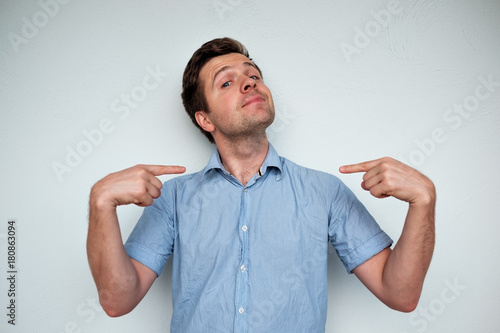 Tapeta Self-satisfied and proud caucasian young man looks forward