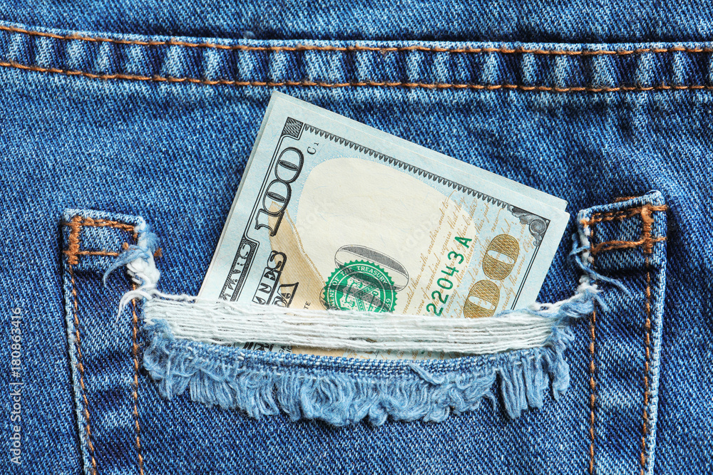 Hundred dollar bill in pocket, closeup Hundred dollar bill in pocket, closeup