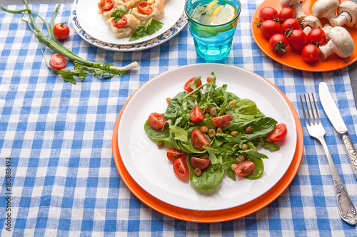 Eating healthy food on checkered tablecloth background.