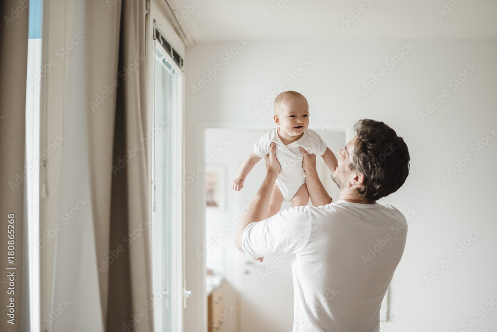 Father holding baby girl at home Father holding baby girl at home