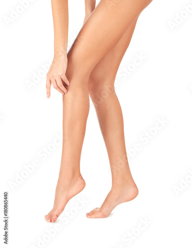 Legs of beautiful young woman on white background