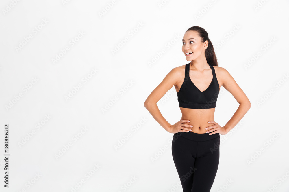 Happy young sports lady posing isolated Happy young sports lady posing isolated