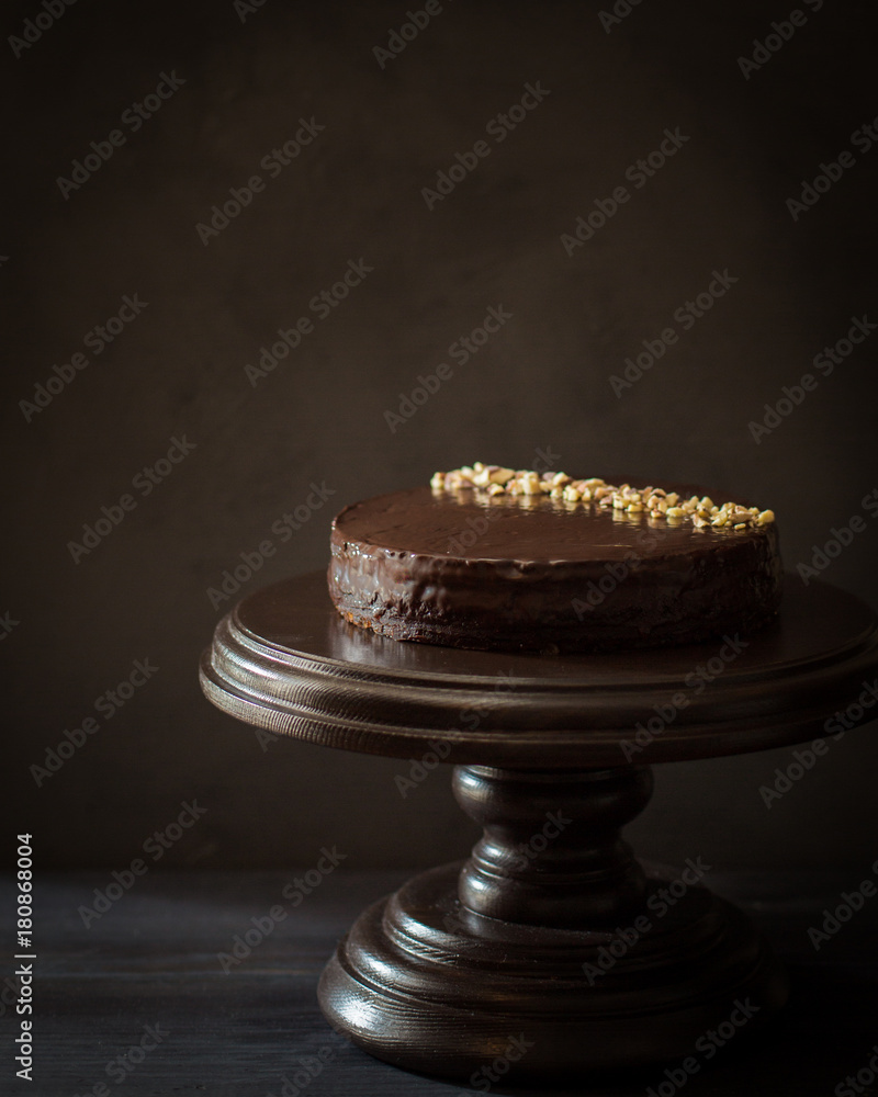 Classic apple chocolate cake with nuts on an  dark wooden background. Copy Space. View blank space for text. Place for text. Food photo. Flat lay, top view