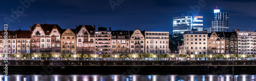 Beautiful panorama of Duesseldorf and the old-town at night. View over the Rhine with typical german old-fashioned architecture and shining city lights © Christophe