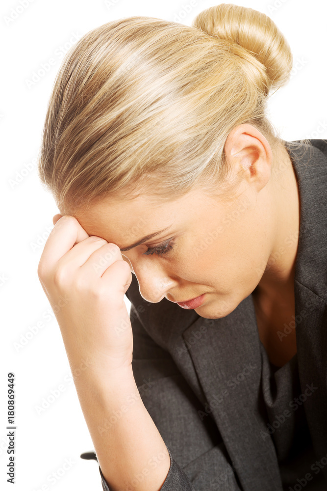 Portrait of depressed businesswoman sitting on armchair Portrait of depressed businesswoman sitting on armchair