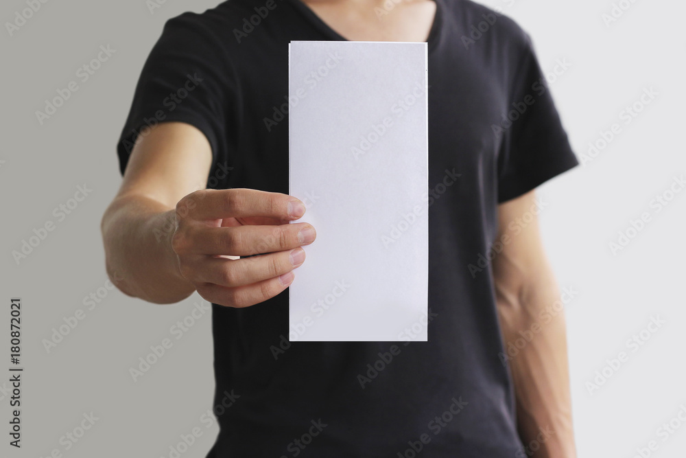 Man showing blank white flyer brochure booklet. Leaflet presentation. Pamphlet hold hands. Man show clear offset paper. Sheet template. Booklet design sheet display read first person Man showing blank white flyer brochure booklet. Leaflet presentation. Pamphlet hold hands. Man show clear offset paper. Sheet template. Booklet design sheet display read first person
