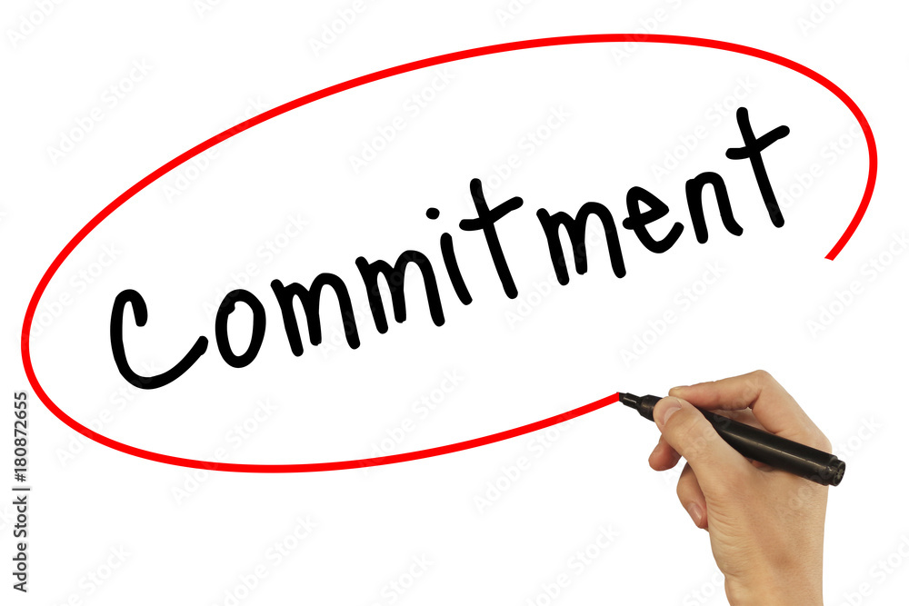 Man Hand writing Commitment with black marker on visual screen. Isolated on background. Business, technology, internet concept. Stock Photo Man Hand writing Commitment with black marker on visual screen. Isolated on background. Business, technology, internet concept. Stock Photo