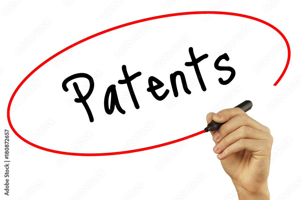 Man Hand writing Patents with black marker on visual screen. Isolated on background. Business, technology, internet concept. Stock Photo Man Hand writing Patents with black marker on visual screen. Isolated on background. Business, technology, internet concept. Stock Photo