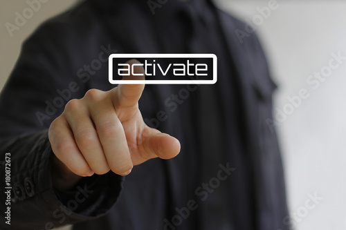 Businessman clicks on the activate button photo