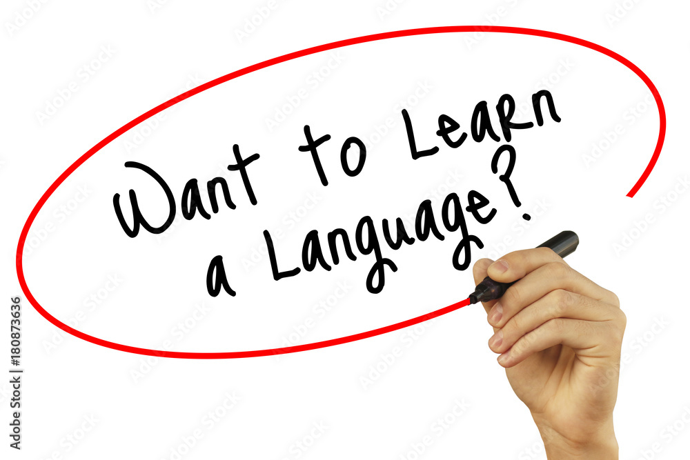 Man Hand writing Want to Learn a Language? with black marker on visual screen. Isolated on background. Business, technology, internet concept. Stock Photo Man Hand writing Want to Learn a Language? with black marker on visual screen. Isolated on background. Business, technology, internet concept. Stock Photo