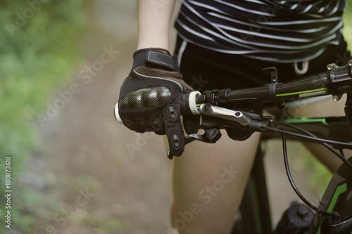 Young girl on bike in gloves
