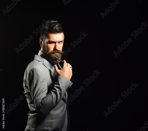 Businessman with serious face isolated on black background