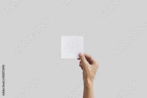 Right hand holding square paper in the right hand. Leaflet presentation. photo