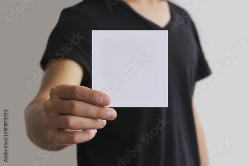Man showing blank white square flyer brochure booklet. Leaflet presentation. Pamphlet hold hands. Man show clear offset paper. Sheet template. Booklet design sheet display read first person