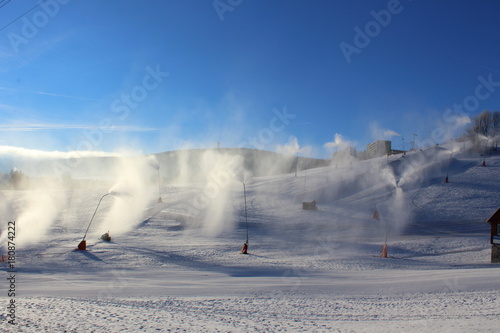 snowmaking with snow cannons and snow lances at ski resort Fichtelberg in Oberwiesenthal, Germany