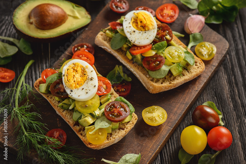 Bruschetta with avocado, egg and tomatoes.