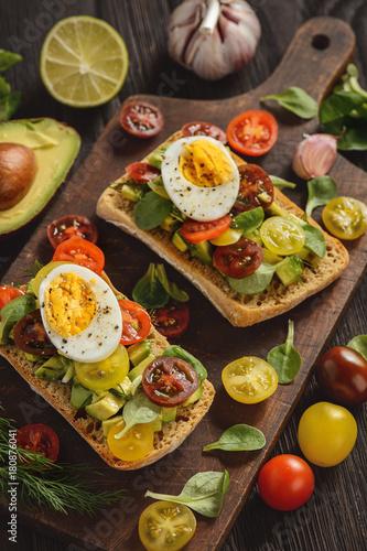 Bruschetta with avocado, egg and tomatoes.