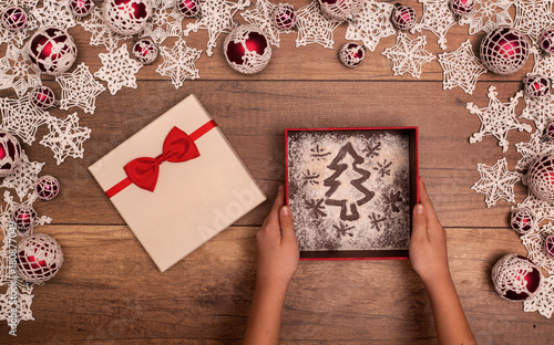 Hands giving or receiving christmas present - in seasonal decorations frame