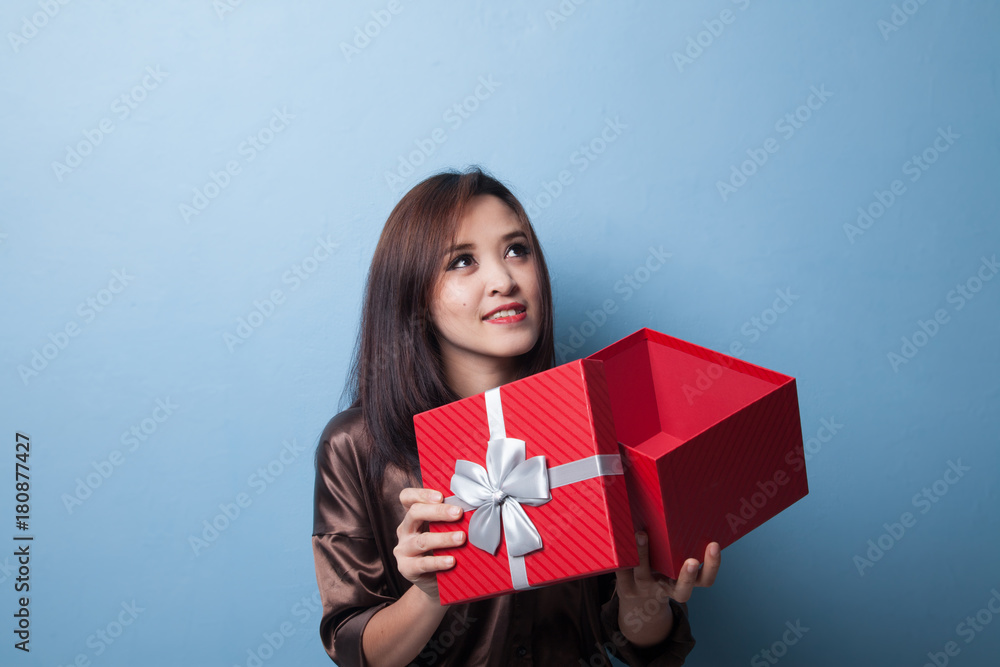 Young Asian woman open a gift box. Young Asian woman open a gift box.