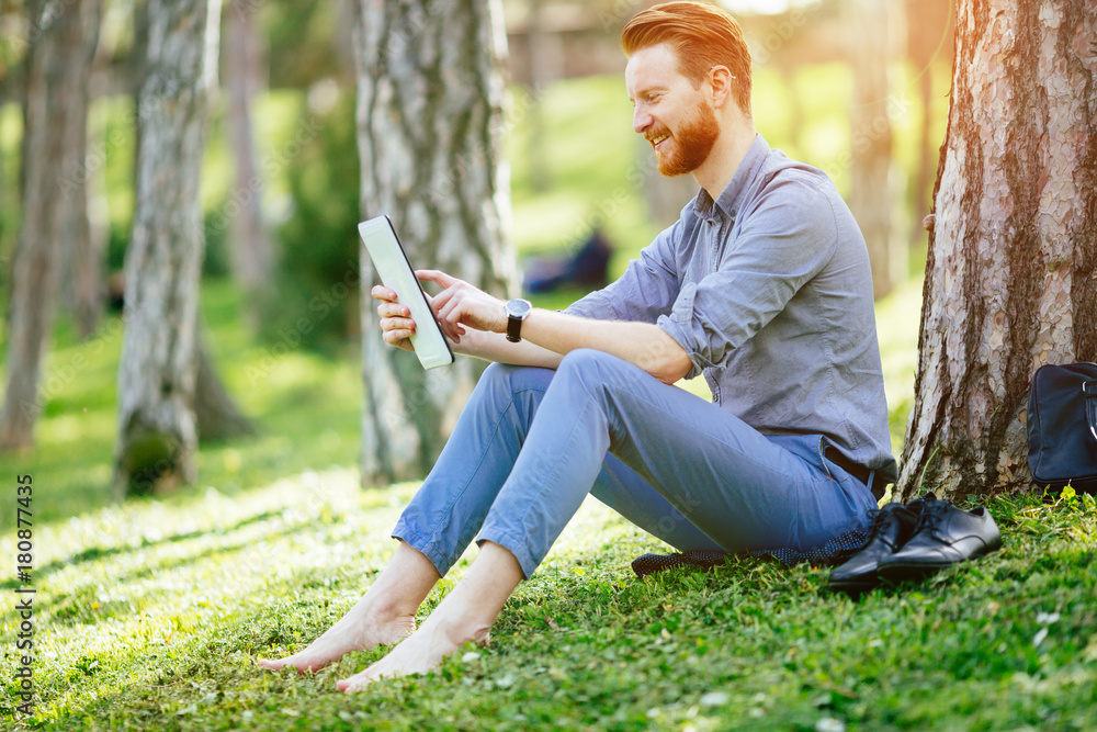 Businessman using tablet in park Businessman using tablet in park