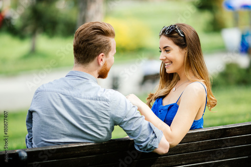 Dating couple sitting on bench