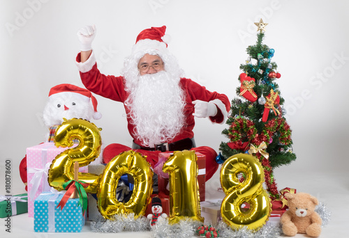 Santa claus with gifts boxs and christmas tree on white background in new year 2018 concept