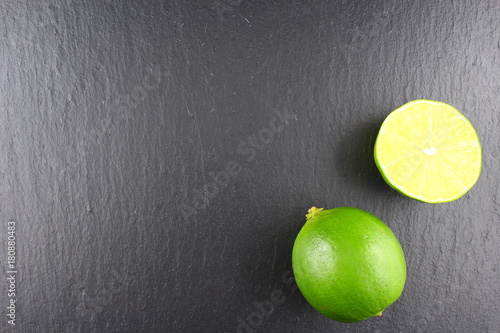 fresh lime fruit on a slate plate food background texture photo