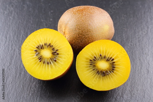fresh yellow kiwi fruits on a slate plate