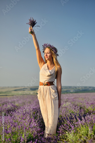 Charming girl in lavender field posing as Statue of Liberty