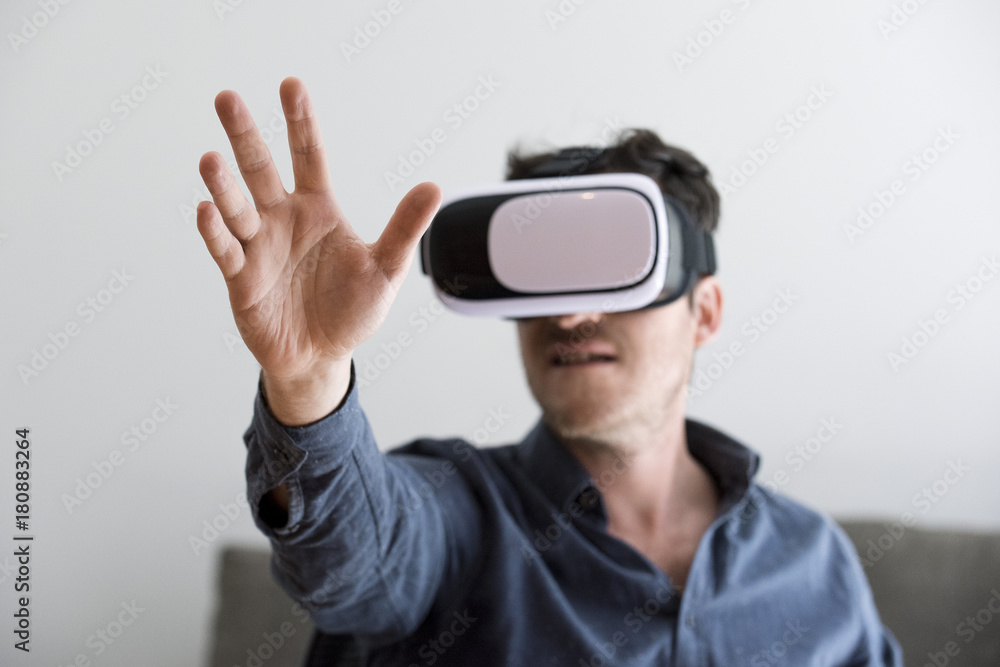 Mid adult man using virtual reality headset Mid adult man using virtual reality headset