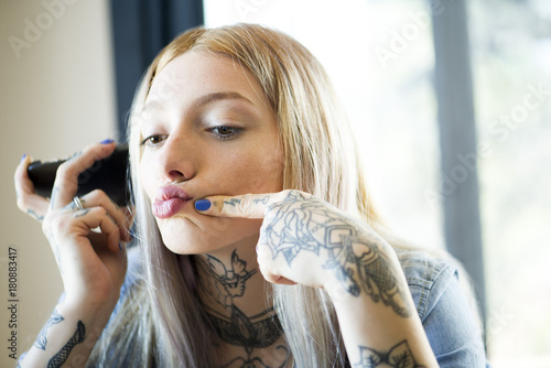 Young woman puckering lips while posing for a selfie